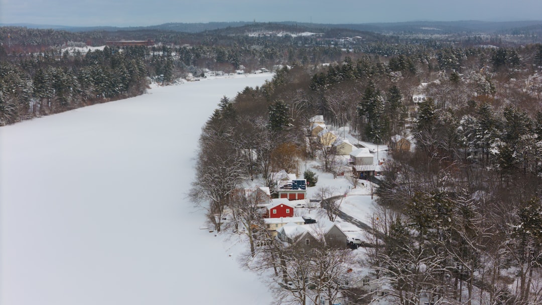 The exterior of a house in winter, with light snow and welcoming outdoor lighting.