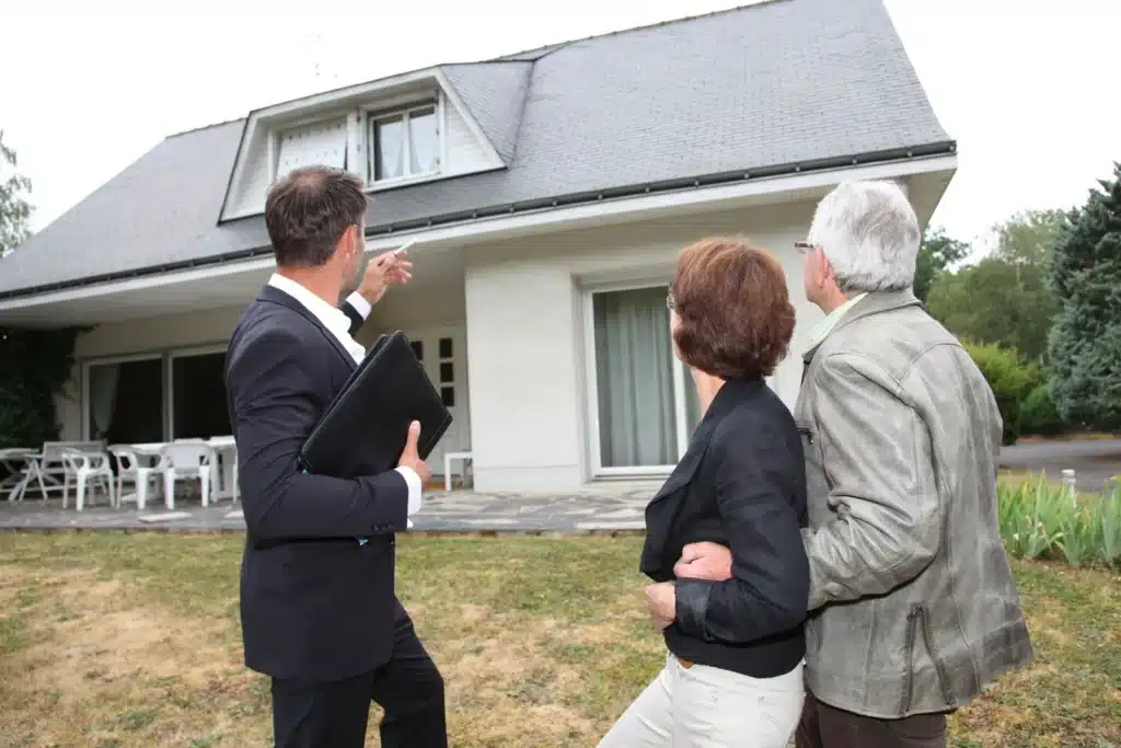 Real estate agent with senior couple buying new house