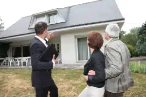 Real estate agent with senior couple buying new house